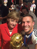 Selfie: Lukas Podolski und Angela Merkel nach der gewonnenen Fußballweltmeisterschaft 2014